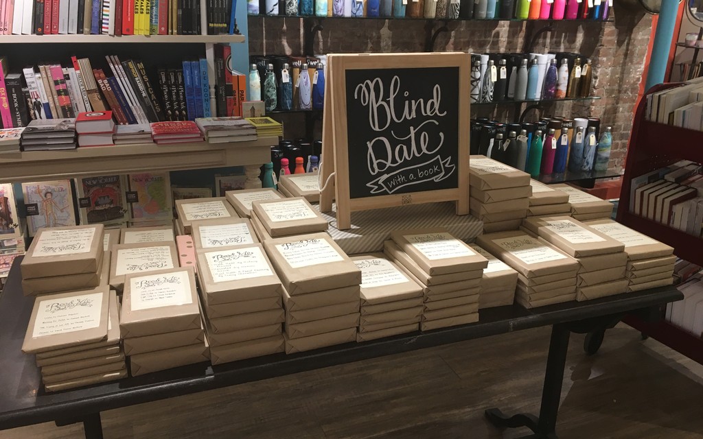 A picure of a bookstand with "blind date" books