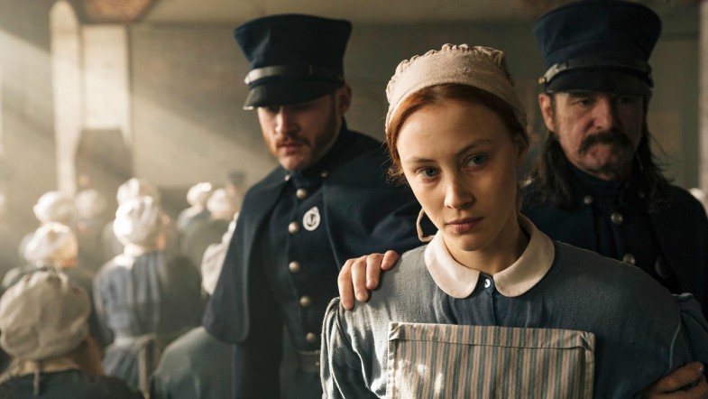 Feature image is a still from the show, which shows Grace Marks being held by the police.