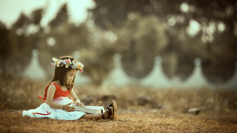 Little girl reading a book