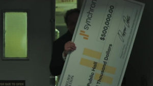 happy holding giant check