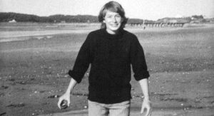 Mary Oliver stands on a beach