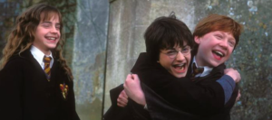 Young Harry Potter cast members smiling with their fake teeth