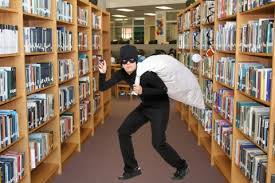 A masked burglar hauls a sack through a library. Dramatization.