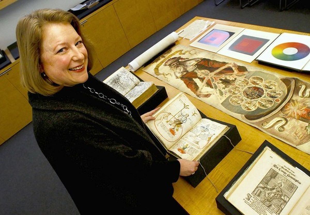 Deborah Harkness looking at ancient text in museum 