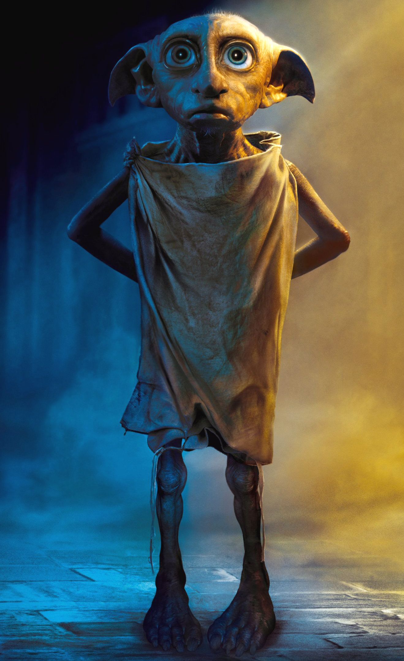 Dobby, a house elf, standing upright with his hands folded behind his back