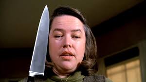 Annie Wilkes staring menacingly with a knife.