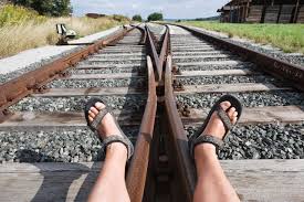 A POV shot of someone lying on traintracks
