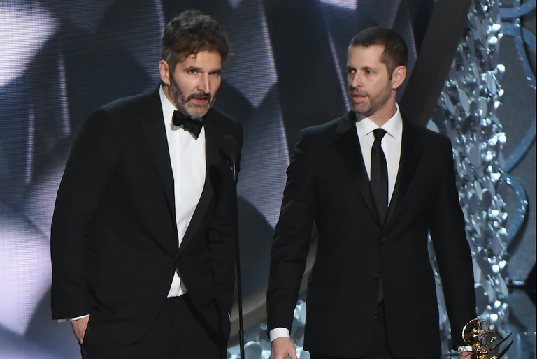 The co-showrunners of Game of Thrones standing side by side before a podium