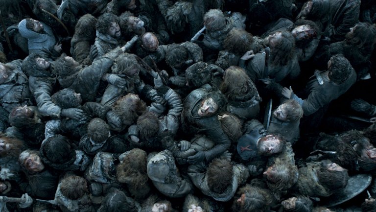 Jon Snow sits amidst a pile of corpses as he struggles to break free