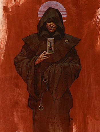 The dark, cloaked figure of Randall Flagg holding a playing card before a red backdrop