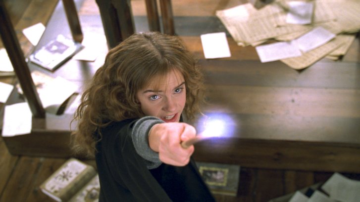 Hermione Granger fires a spell upwards in a library