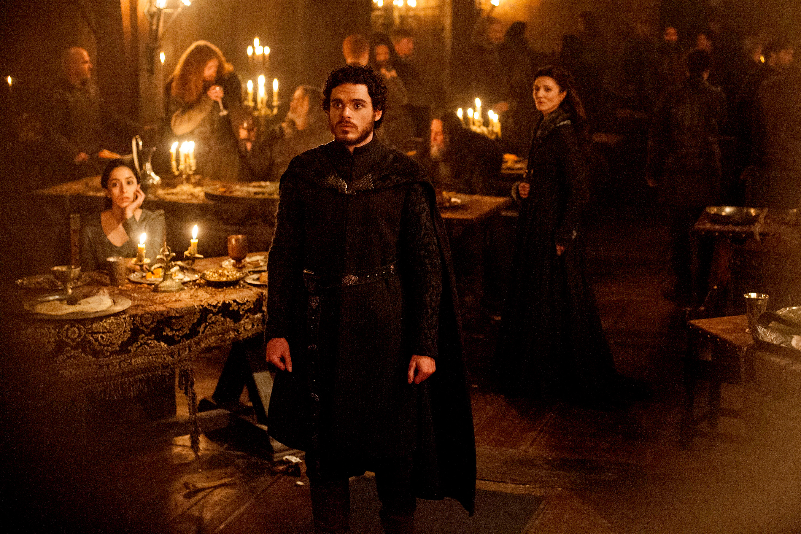 Several GOT characters stand around in the infamous Red Wedding massacre