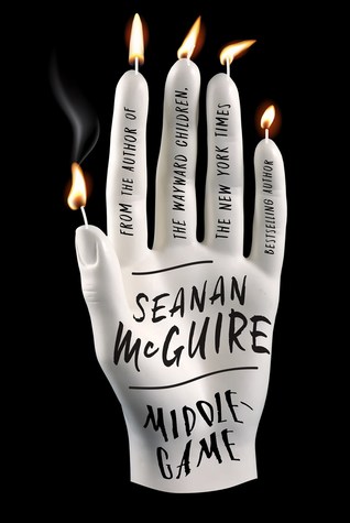 A hand covered in candles burning in a dark void 