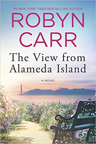 A beautiful view of an island with mountains rising in the distance around the Golden Gate Bridge
