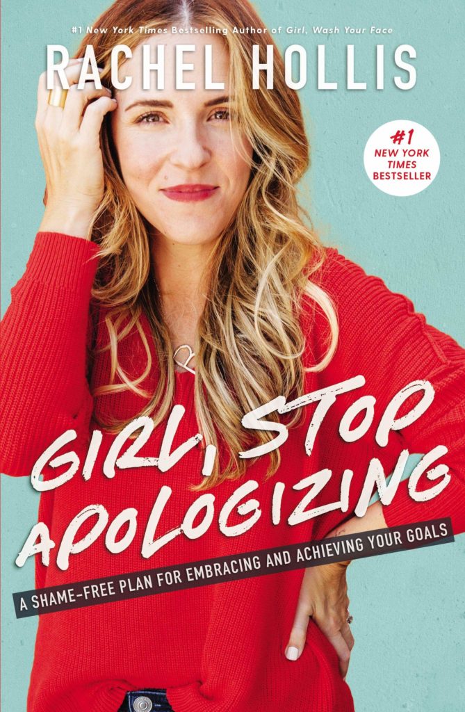 A woman runs a hand through her hair as she smugly faces the reader