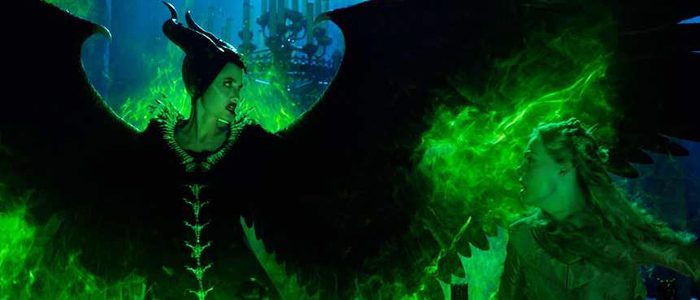 Maleficent stands side by side with Aurora, Maleficent wreathed in green flames and spreading her black wings