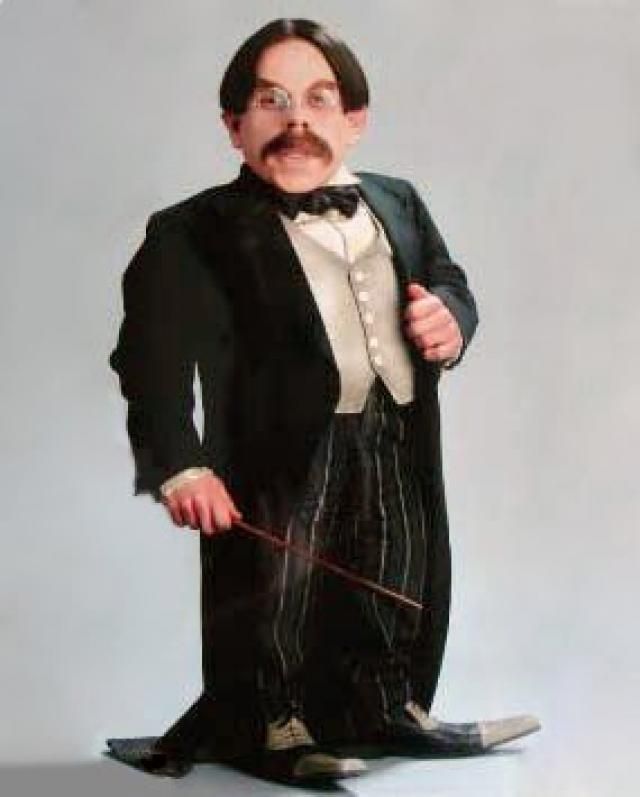 The diminutive Filius Flitwick standing in a tuxedo and holding a wand
