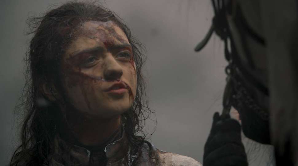Arya, face bloodied, stares at the pale horse