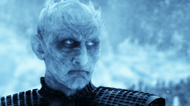 The icy visage of the Night King with horns and armor standing before an icy wasteland