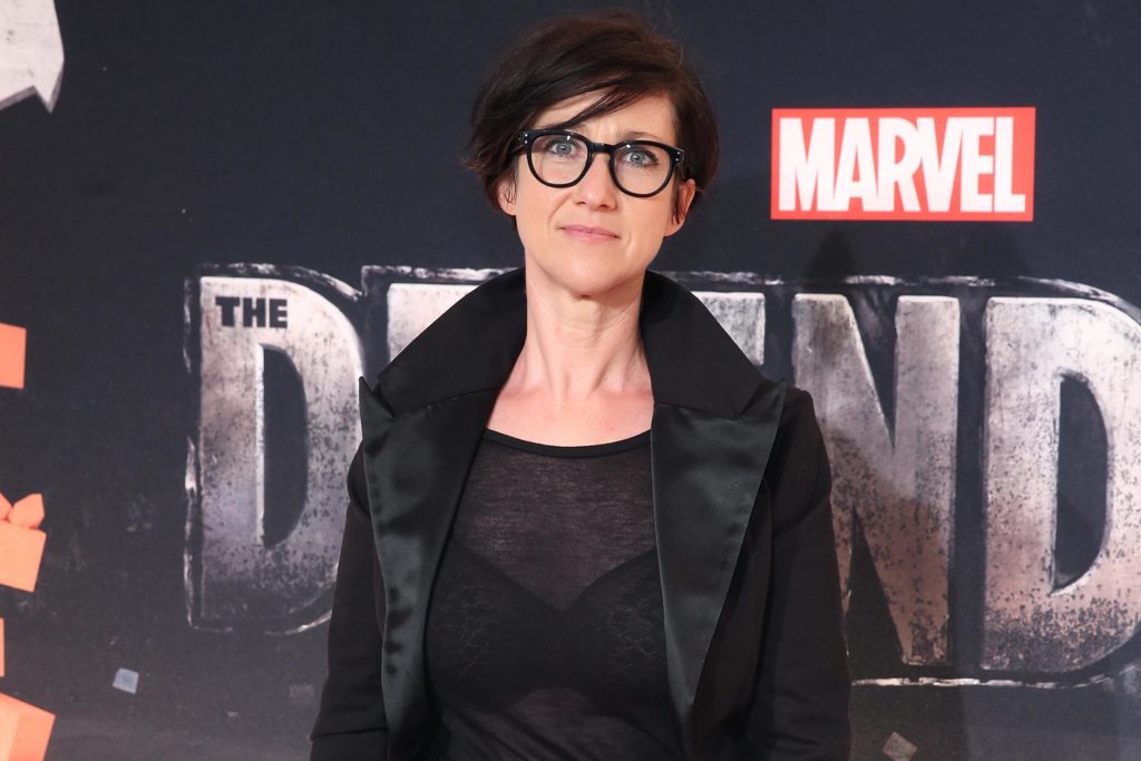 S.J. Clarkson in front of Marvel 'Defenders' Poster