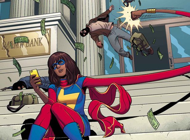 Superhero Ms. Marvel stretches her arm and punches out a bank robber while reading her phone