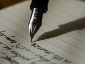 Fountain pen writing in black ink on lined paper