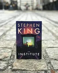 The Institute book by Stephen King on gray brick ground