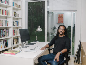 Colson whitehead sitting at desk