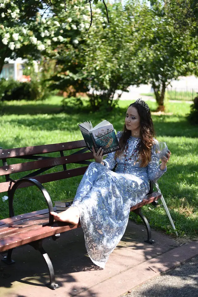 Image of a woman sitting comfortably on a bench reading