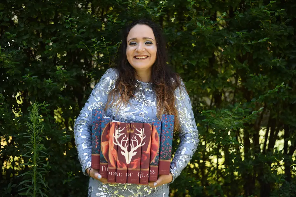 Image of a woman holding a set of books