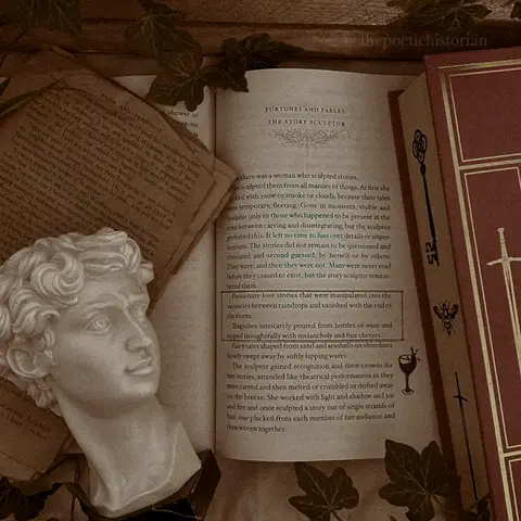 Image of an open book with a statue head and another book in the frame
