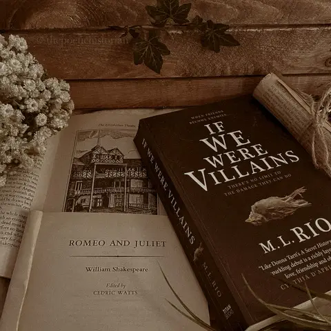 Image of several open books sitting on a wooden desk
