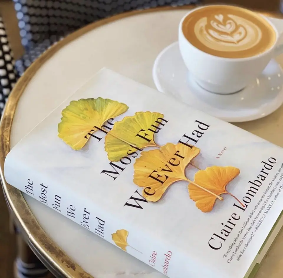 A book sitting on a table next to a cup of coffee