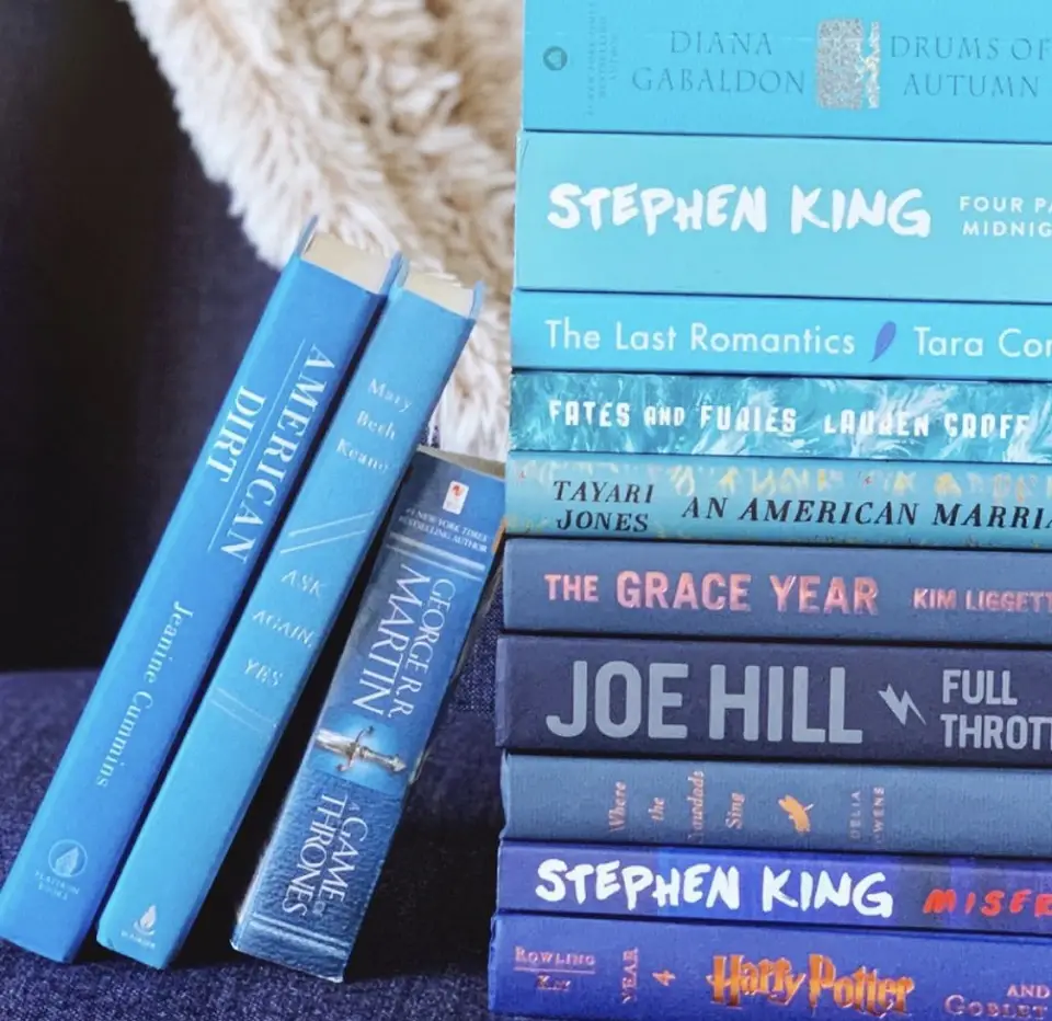 Image of a stack of books with several other books leaning against the stack